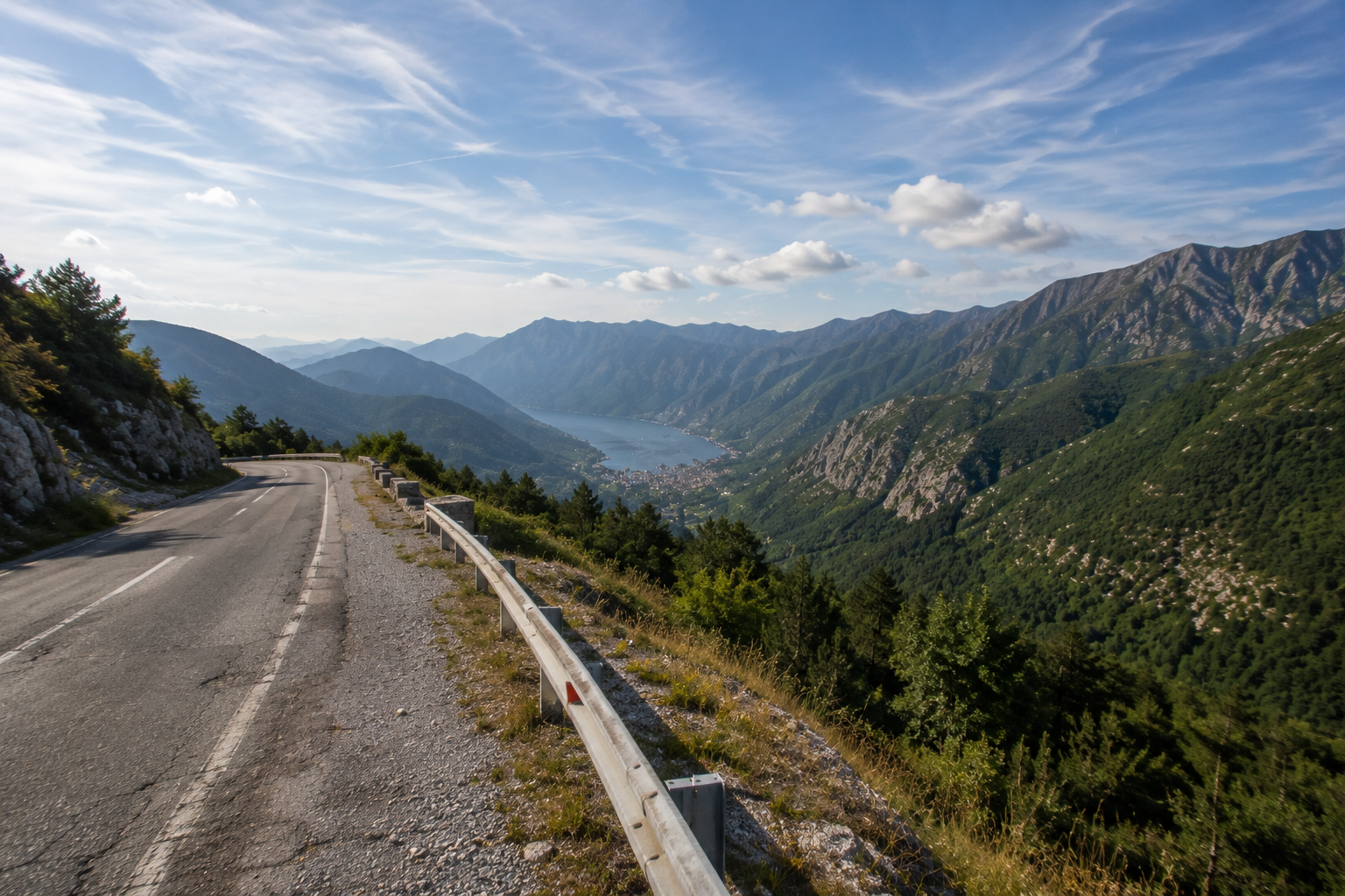 Scenic European road through mountain valleys symbolising sustainable long-distance transport